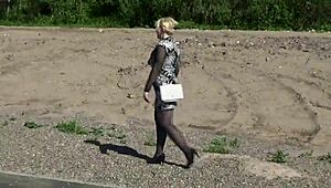 a blonde pornstar walks around flashing her pussy in a solo scene