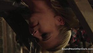 dominating mistress guides bound lesbian in tight strapon play