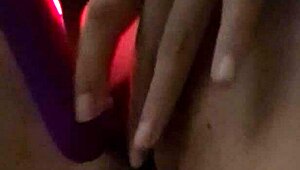 Amateur woman demonstrates toy use in homemade setting