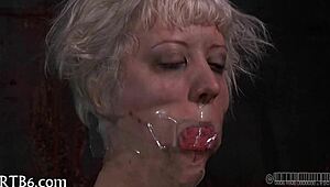 in the dungeon, a dominant woman controls her submissive partner with whips and chains