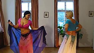 two plump belly dancers slowly undress on stage