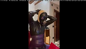 Wearing a tight gas mask for intense latex-rubber fetish play