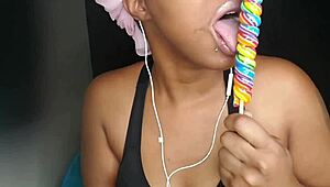 Cute ebony chick sucking lollipop with a naughty twist 😏