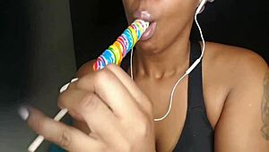 Cute ebony chick sucking lollipop with a naughty twist 😏