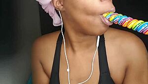 Cute ebony chick sucking lollipop with a naughty twist 😏