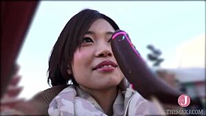 A Japanese babe gives a deepthroat blowjob with a naughty look