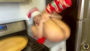 Destiny Cruz in Christmas outfit interacts with Rome Major on kitchen counter