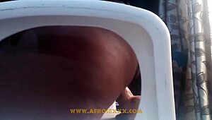 African woman in mini skirt pleasures herself on chair
