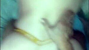 She's bent over in her yellow thong, taking it doggystyle.