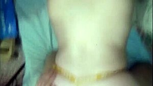 She's bent over in her yellow thong, taking it doggystyle.