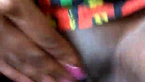 Ebony woman uses dildo for masturbation