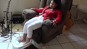 Asian woman enjoys messy barefoot foot bath