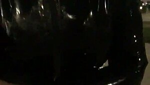 cd in latex walks outdoors with vibrator attached