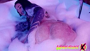 Inked babe in the bathtub starts masturbating, her fingers diving into that tight pussy.