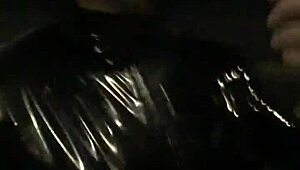 cd in latex walks outdoors with vibrator attached