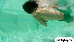 Girl in monofins swims topless for cash in public.