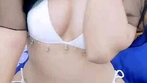 asian stripper teasing with clothes ripped during striptease