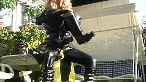 Roxina Torpedo Doll Stuns in Rubber Outfit at Garden Scene. Nature Meets Kink in Wild Display.