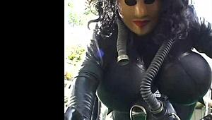 Roxina Torpedo Doll Stuns in Rubber Outfit at Garden Scene. Nature Meets Kink in Wild Display.