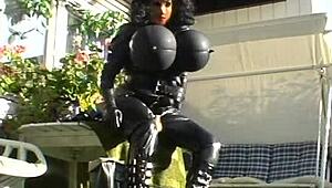 Roxina Torpedo Doll Stuns in Rubber Outfit at Garden Scene. Nature Meets Kink in Wild Display.