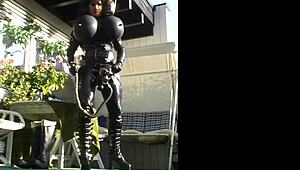 Roxina Torpedo Doll Stuns in Rubber Outfit at Garden Scene. Nature Meets Kink in Wild Display.