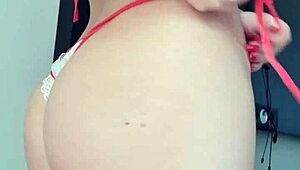 blonde woman teases in towel by the window