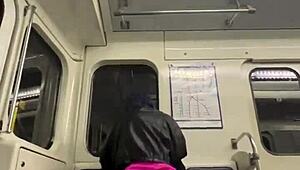Passionate couple engages in open-air intimacy on a commuter train