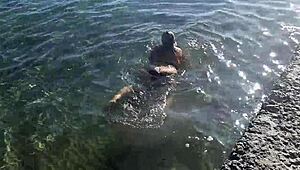 Milf plays with her big tits and ass on public beach