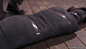 Mummified Brunette Endures Intense Whipping