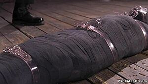 Mummified Brunette Endures Intense Whipping