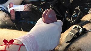 the mistress jerks my cock with white gloves, and i cum as she uses the dilator on my urethra