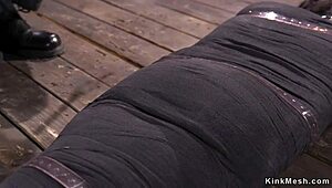 Mummified Brunette Endures Intense Whipping