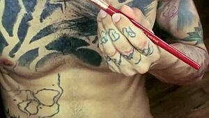 Guy plays with his cum like paint