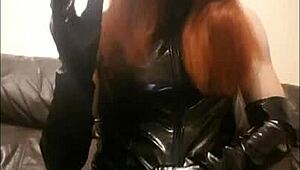 A transsexual woman in PVC smokes two cigarettes at once