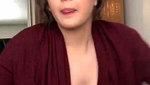 Sexy beauty admires her tits in the mirror