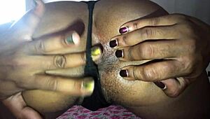 Slim black woman in thong teases and exposes her asshole on bed