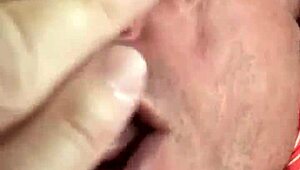 Rear view of gay deepthroat gagging and choking on hairy cock.