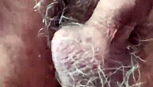 Rear view of gay deepthroat gagging and choking on hairy cock.