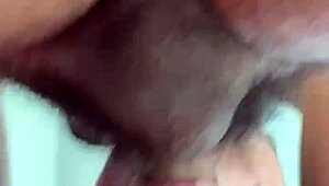 Rear view of gay deepthroat gagging and choking on hairy cock.