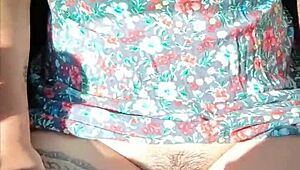 Latina with tattoos flaunts her body in a moving car