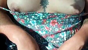 Latina with tattoos flaunts her body in a moving car