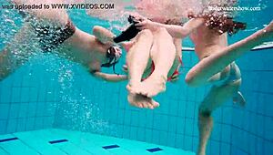 Three babes indulge in underwater pleasure in a pool