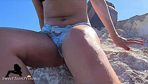brunette pisses at the beach and teases her boyfriend by touching her pussy