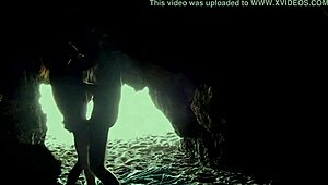 A couple's intimate encounter in a secluded beach cave