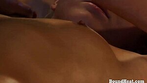 Handcuffed lesbian enjoys oiled massage from mistress