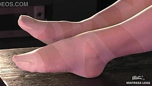 Goddess in white pantyhose teasing nylon toes on desk