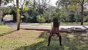 A Brazilian woman dances in the street, watched by her husband and a stranger