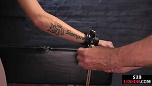 Bound submissive interacts with dominant in lingerie setting