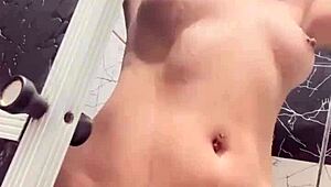 Sko ella boldly shows off her pussy, boobs, and tattooed tits in the shower