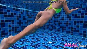 Asian beauty enjoys swimming with her anal toy in place